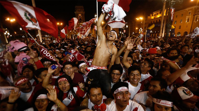 Supporters of Peru celebrate a goal against New Zealand during the 2018 World Cup qualifying play-off second leg football match, at the Plaza Mayor square in Lima, Peru, on November 15, 2017. STR / AFP