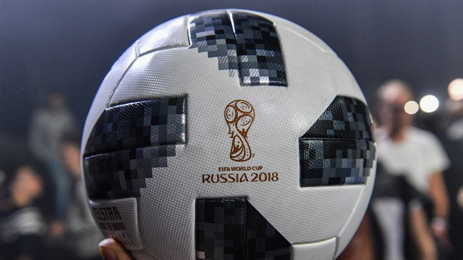 A participant holds the official match ball for the 2018 World Cup football tournament, named "Telstar 18", during its unveiling ceremony in Moscow on November 9, 2017. Mladen ANTONOV / AFP