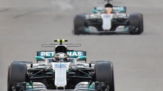 Mercedes' Finnish driver Valtteri Bottas steers his car followed by Mercedes' British driver Lewis Hamilton during the Abu Dhabi Formula One Grand Prix at the Yas Marina circuit on November 26, 2017. Giuseppe CACACE / AFP