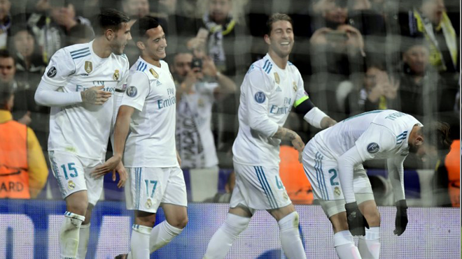 Champions Real Madrid's Spanish midfielder Lucas Vazquez (L) celebrates a goal with teammates during the UEFA Champions League group H football match Real Madrid CF vs Borussia Dortmund at the Santiago Bernabeu stadium in Madrid on December 6, 2017. JAVIER SORIANO / AFP