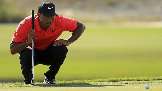 FILES) This file photo taken on December 3, 2017 shows Tiger Woods of the United States lining up a putt on the 18th hole during the final round of the Hero World Challenge at Albany, Bahamas in Nassau, Bahamas. Tiger Woods returns to US PGA Tour competition on January 25, 2018 playing alongside Patrick Reed and Charley Hoffman in the first round of the Farmers Insurance Open at Torrey Pines. The 14-time major champion, whose eight professional wins at Torrey Pines include the 2008 US Open, will tee off on the South Course at 10:40 a.m. (18:30 GMT), on Thursday, according to the tee times announced on January 23, 2018.