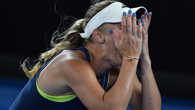 Denmark's Caroline Wozniacki celebrates beating Romania's Simona Halep in their women's singles final match on day 13 of the Australian Open tennis tournament in Melbourne on January 27, 2018. Greg Wood / AFP