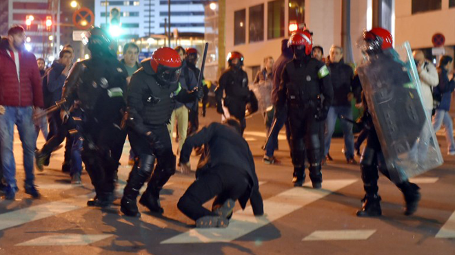 Basque autonomous police officers break up a group of Athletic Bilbao fans outside the San Mames stadium before the Europa League Round of 32 second leg football match between Athletic Club Bilbao and FC Spartak Moscow at the San Mames stadium in Bilbao on February 22, 2018. ANDER GILLENEA / AFP