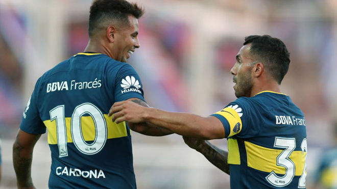 Boca Juniors' forward Carlos Tevez (R) celebrates with his teammate Colombian midfielder Edwin Cardona after scoring a goal against San Lorenzo during their Argentina First Division Superliga football match at Pedro Bidegain stadium, in Buenos Aires, on February 4, 2018. ALEJANDRO PAGNI / AFP