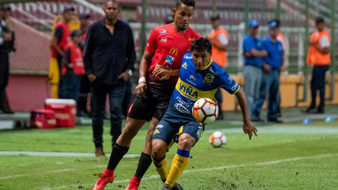 Oscar Salinas (R) of Chile's Everton vies for the ball with Edwuin Pernia of Venezuela's Caracas FC during their Copa Sudamericana 2018 football match held at the Metropolitano stadium in Barquisimeto, Venezuela, on March 6, 2018. Emmanuel Garcia / AFP