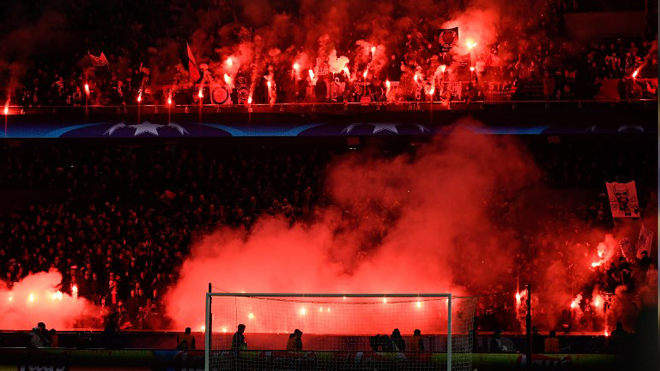 Paris Saint-Germain's supporters burn flares the UEFA Champions League round of 16 second leg football match between Paris Saint-Germain (PSG) and Real Madrid on March 6, 2018, at the Parc des Princes stadium in Paris. CHRISTOPHE SIMON / AFP