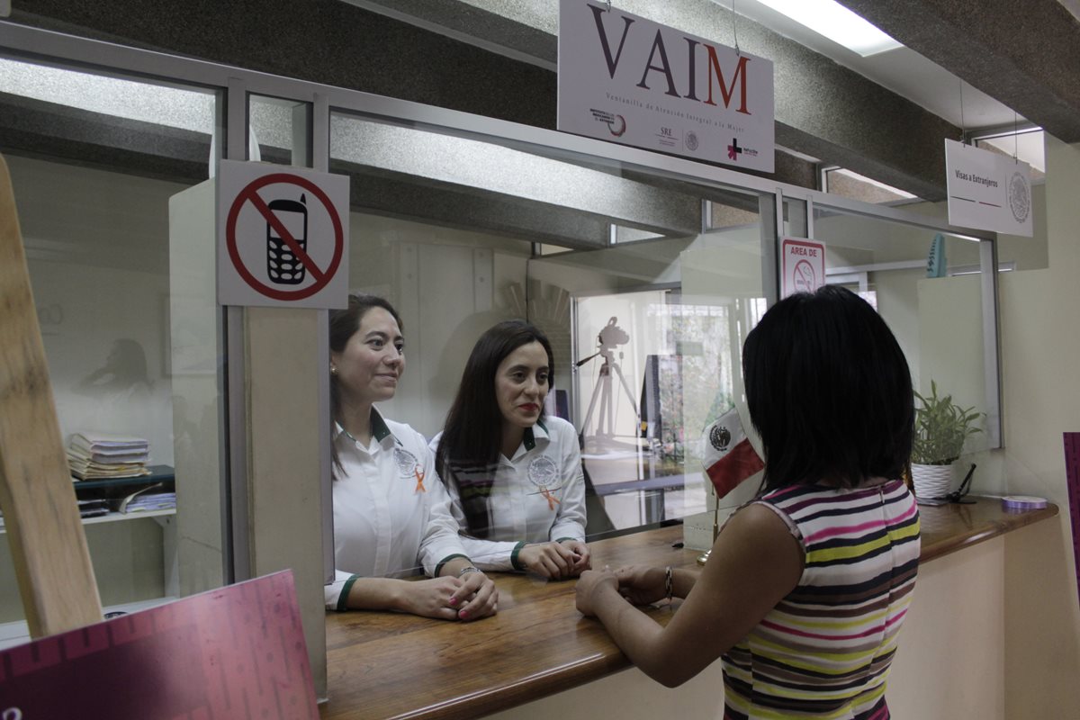 Dos funcionarias mexicanas atienden a una mujer en el primer día de la inauguración de la oficina. (Foto Prensa Libre: María José Longo)