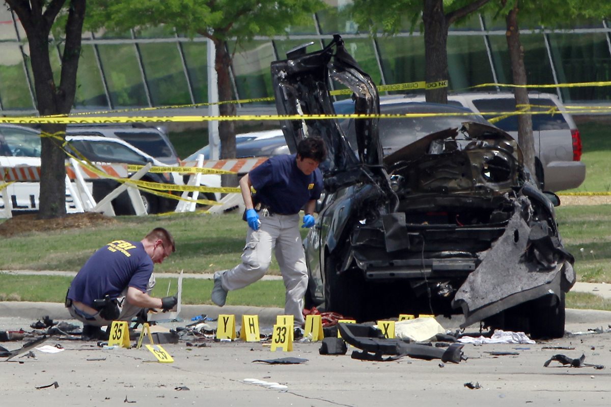 La Policía inspecciona el vehículo donde llegaron los dos atacantes que pretendían asesinar a los asistentes a la exposición. (Foto Prensa Libre: AFP).