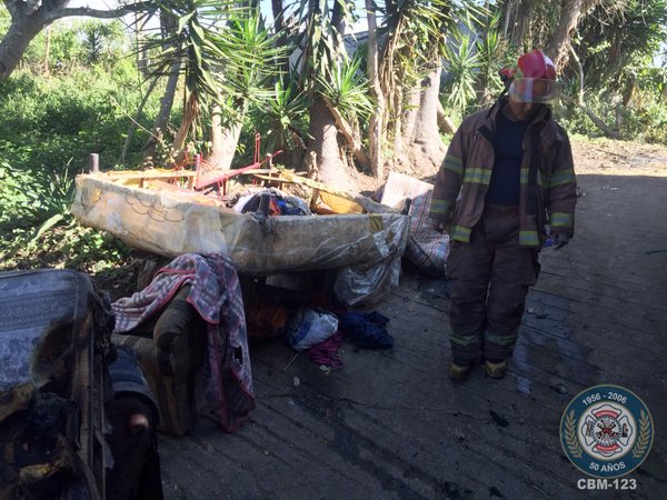 Un Bomberos Municipal descombra la vivienda, para identificar los daños luego del incendio. (Foto Prensa Libre: Cortesía CBM)