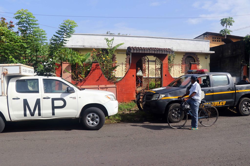 Agentes de la Policía Nacional Civil y del Ministerio Público buscan pistas en la vivienda donde fue localizada la docente Lilian Cecilia de Paz Saquic. (Foto Prensa Libre: Rolando Miranda)