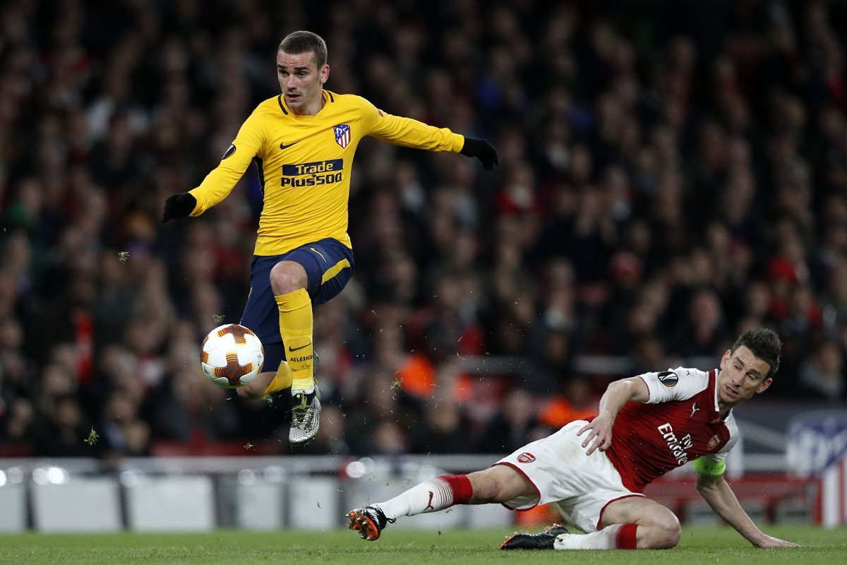 Antoine Griezmann le gana el duelo a Laurent Koscielny, en la jugada que puso la igualdad frente al Arsenal. (Foto Prensa Libre: AFP)