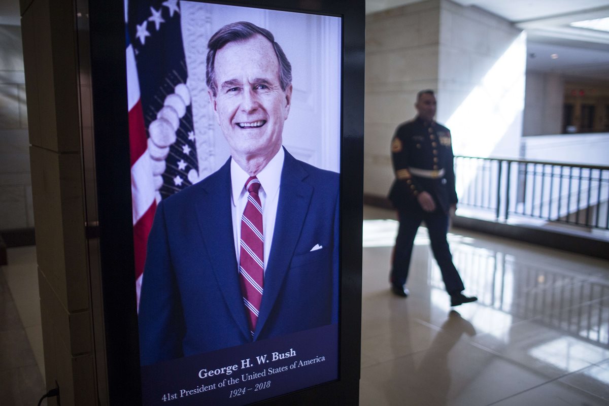 Una pantalla digital muestra al expresidente George H.W. Bush, en el Capitolio. (Foto Prensa Libre: AFP)