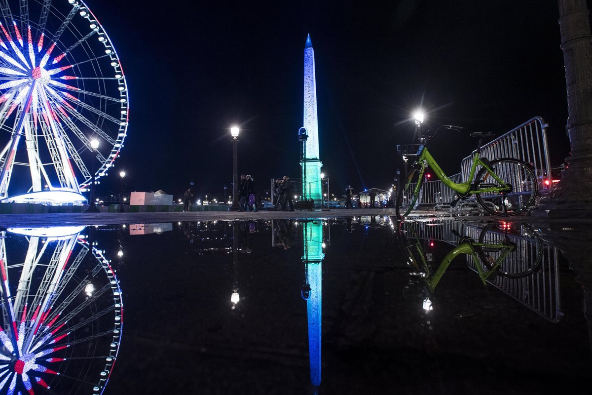 El Obelisco de Luxor en el centro de la Place de la Concorde se ilumina de verde y azul, los colores oficiales de la cumbre "Un Planeta", en París, Francia. (Foto Prensa Libre: EFE)