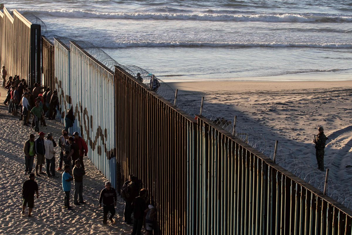 Centroamericanos se acercan al muro fronterizo entre México y Estados Unidos en el estado mexicano de Tijuana. (Foto Prennsa Libre: AFP)