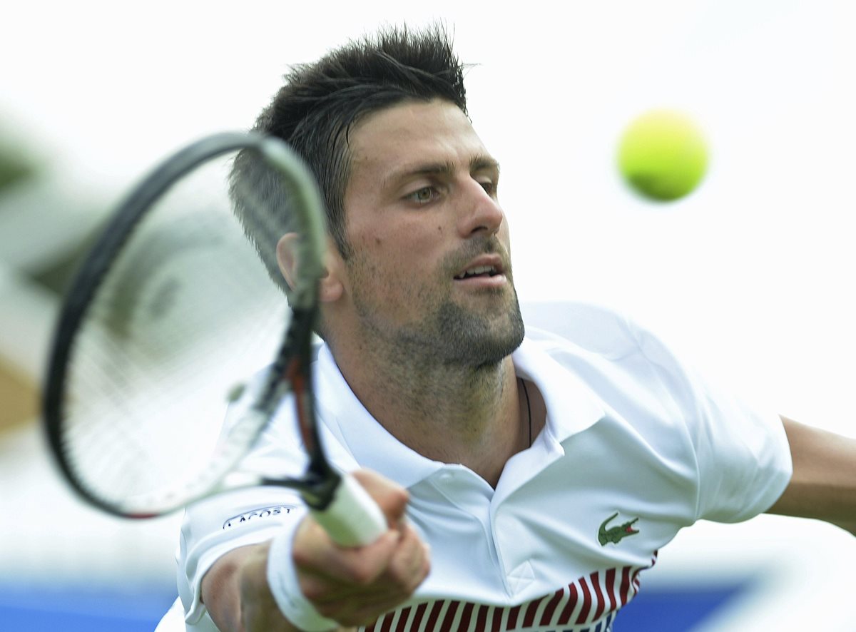 El tenista serbio Novak Djokovic devuelve la bola al ruso Daniil Medvedev. Semifinal del torneo Aegon en Eastbourne. (Foto Prensa Libre: EFE)