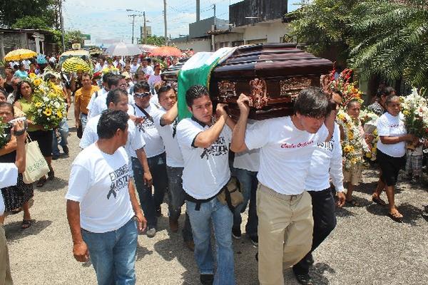 Vecinos, familiares y amigos acompañan el féretro del comunicador Carlos Orellana.