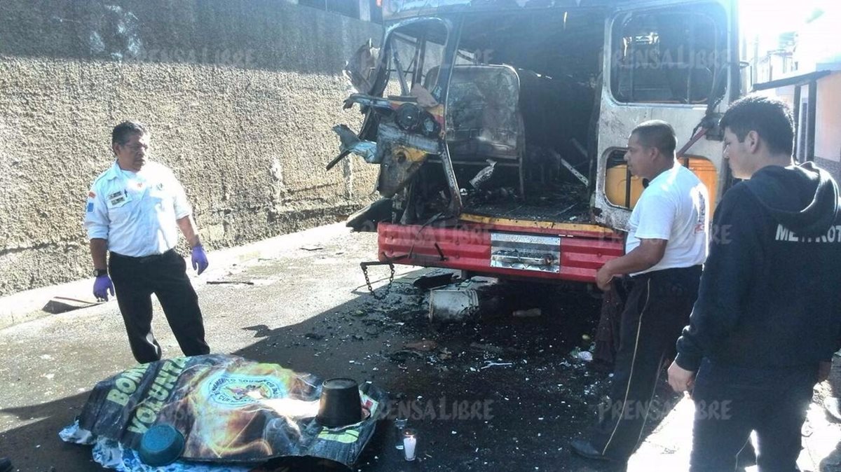 La víctima mortal quedó tirada por la fuerte explosión en la parte de atrás del bus. (Foto Prensa Libre: Estuardo Paredes)