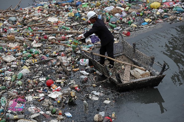 Un voluntario realiza trabajos de limpieza en la playa de Río de Janeiro. (Foto Prensa Libre: AFP)