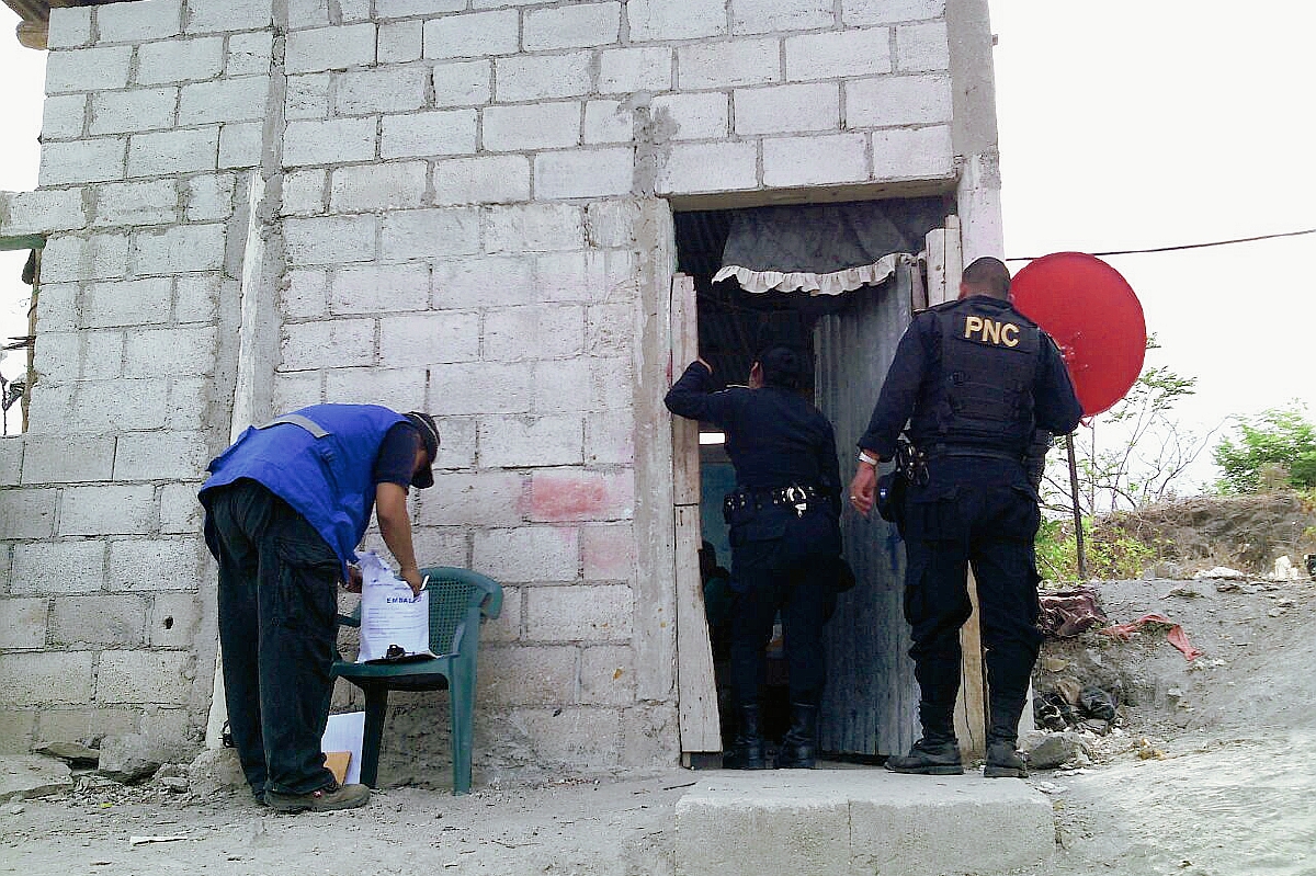 Agentes de  la PNC revisan un inmueble en la aldea Loma del Viento, Zacapa, en donde encontraron partes de motocicletas. (Foto Prensa Libre: Víctor Gómez)