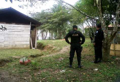 Fuerzas especiales de la PNC observan la vivienda donde ocurrió la matanza de ocho personas. (Foto Prensa Libre: Rigoberto Escobar)