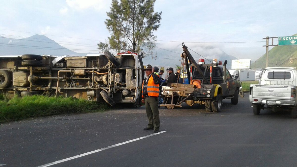 Una grúa intenta retirar del camino el microbús volcado en el kilómetro 30 de la ruta al Pacífico. (Foto Prensa Libre: Provial)