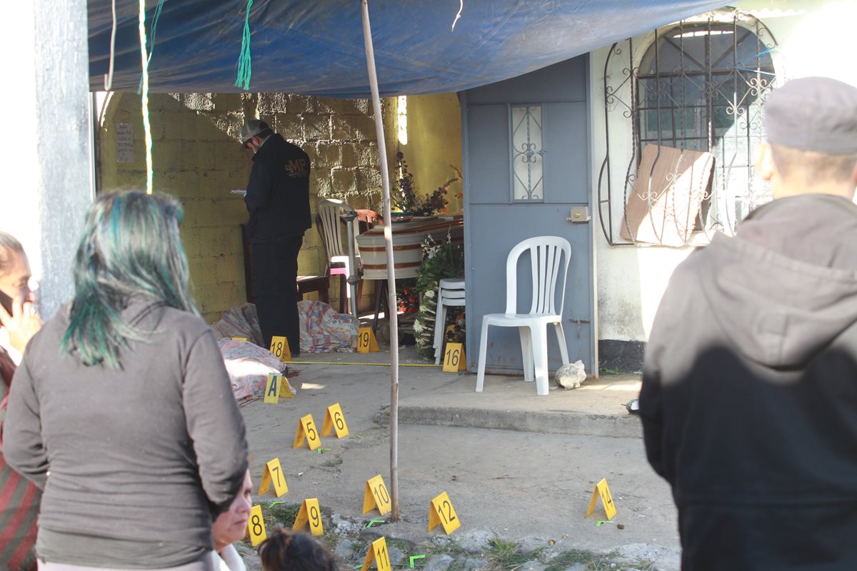 Vecinos observan diligencia policial en casa donde ocurrió el ataque. (Foto Prensa Libre: Estuardo Paredes)