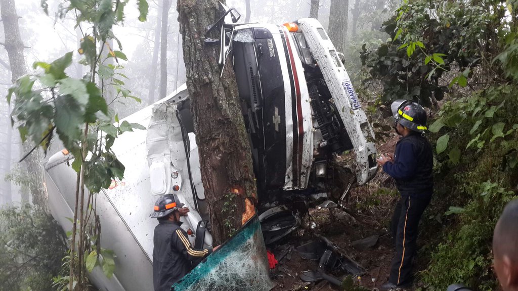 Bomberos rescatan a pasajeros de un camión que cayó a un barranco en la ruta Interamericana. (Foto Prensa Libre: Bomberos Voluntarios)