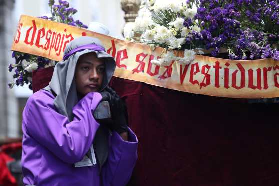 Un joven descansa después de llevar el anda de Jesús Flagelado