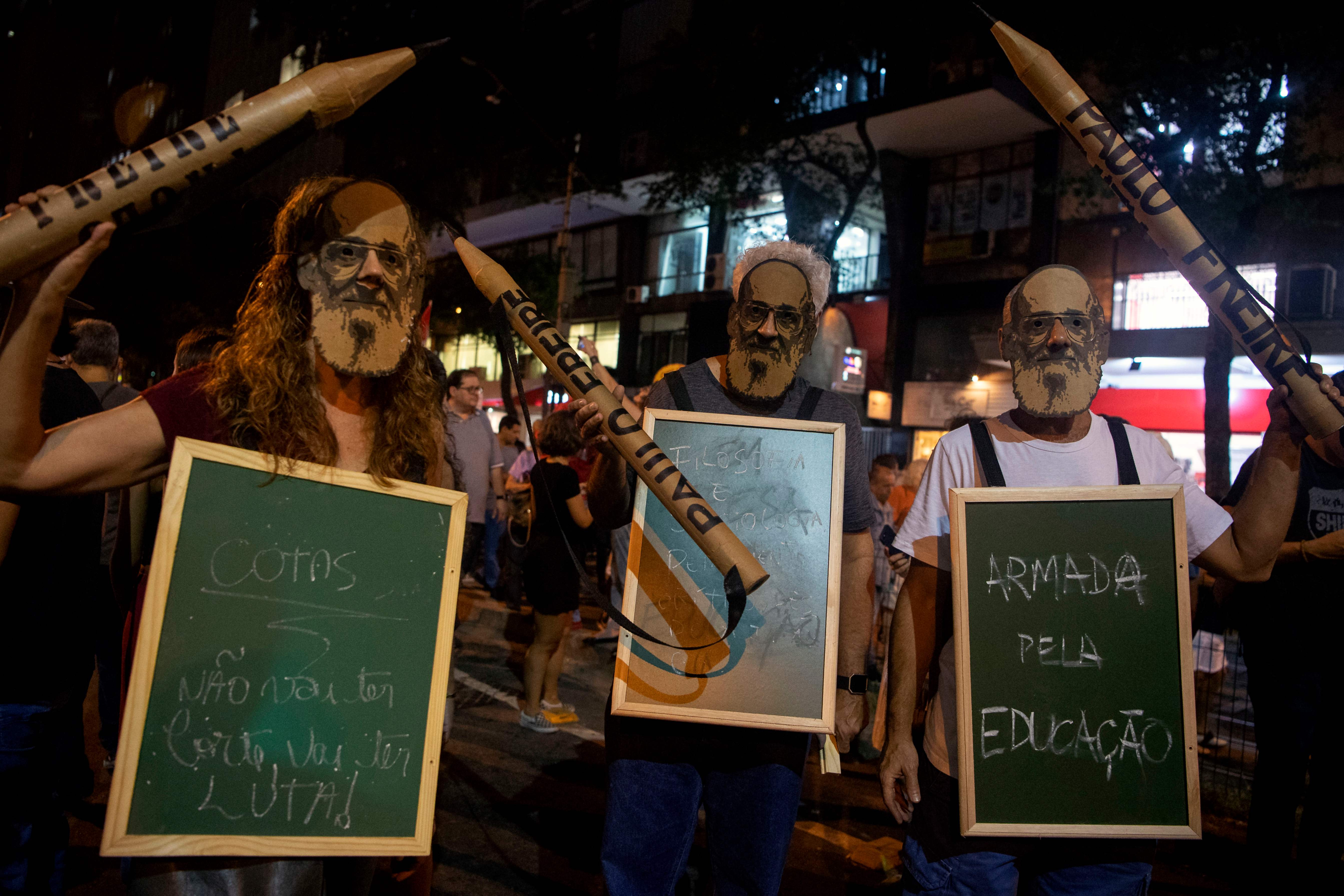 Manifestantes llevan máscaras del famoso educador y filósofo brasileño Paulo Freire durante una manifestación en apoyo y defensa de la educación pública tras una serie de recortes presupuestarios anunciados por el gobierno del presidente Jair Bolsonaro, en Río de Janeiro, Brasil, el 30 de mayo de 2019. - (Foto de archivo de MAURO PIMENTEL / AFP)