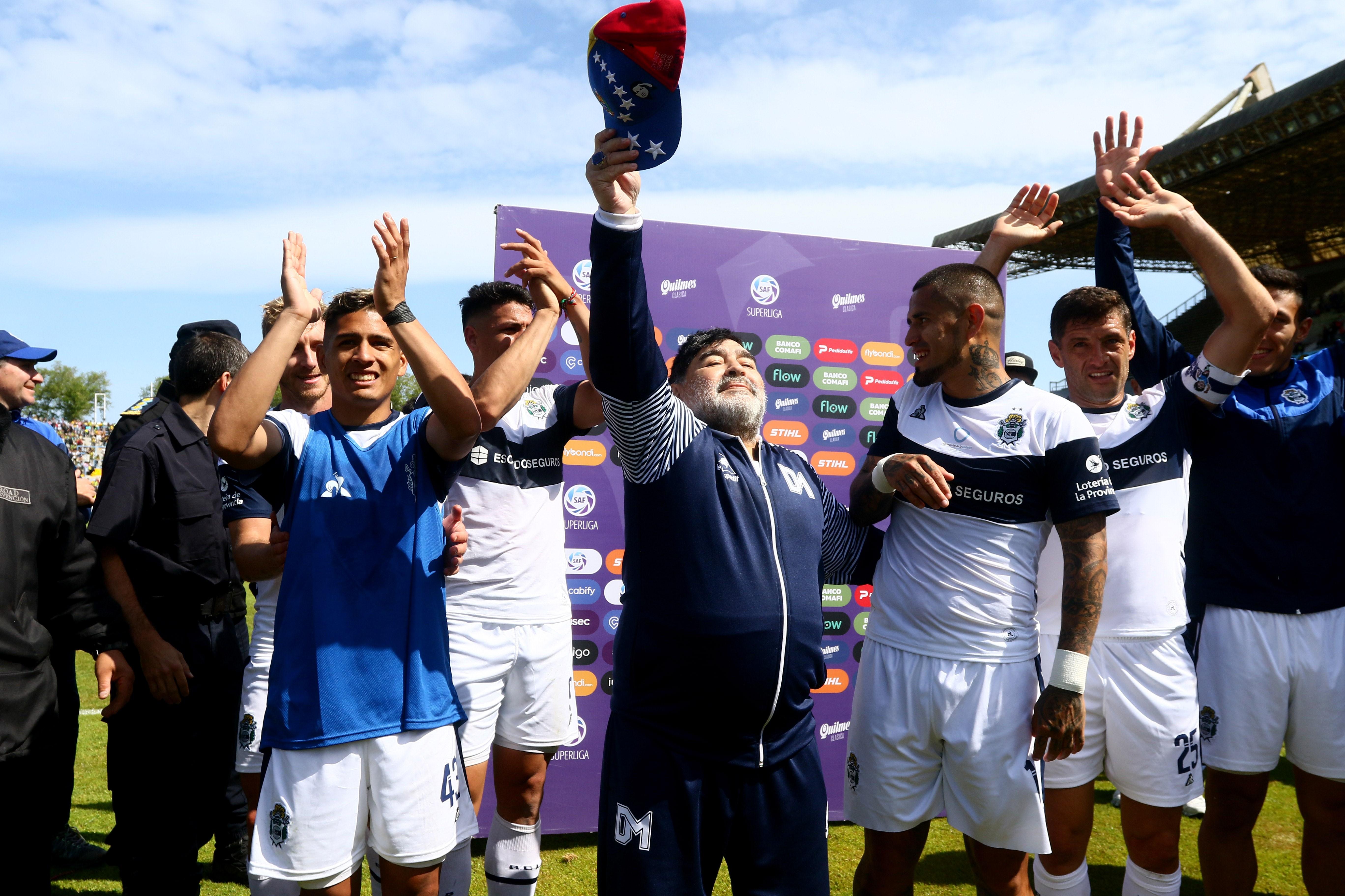 El director técnico de Gimnasia y Esgrima, el exfubtolista argentino Diego Maradona (c), festeja con sus pupilos. (Foto Prensa Libre: EFE)