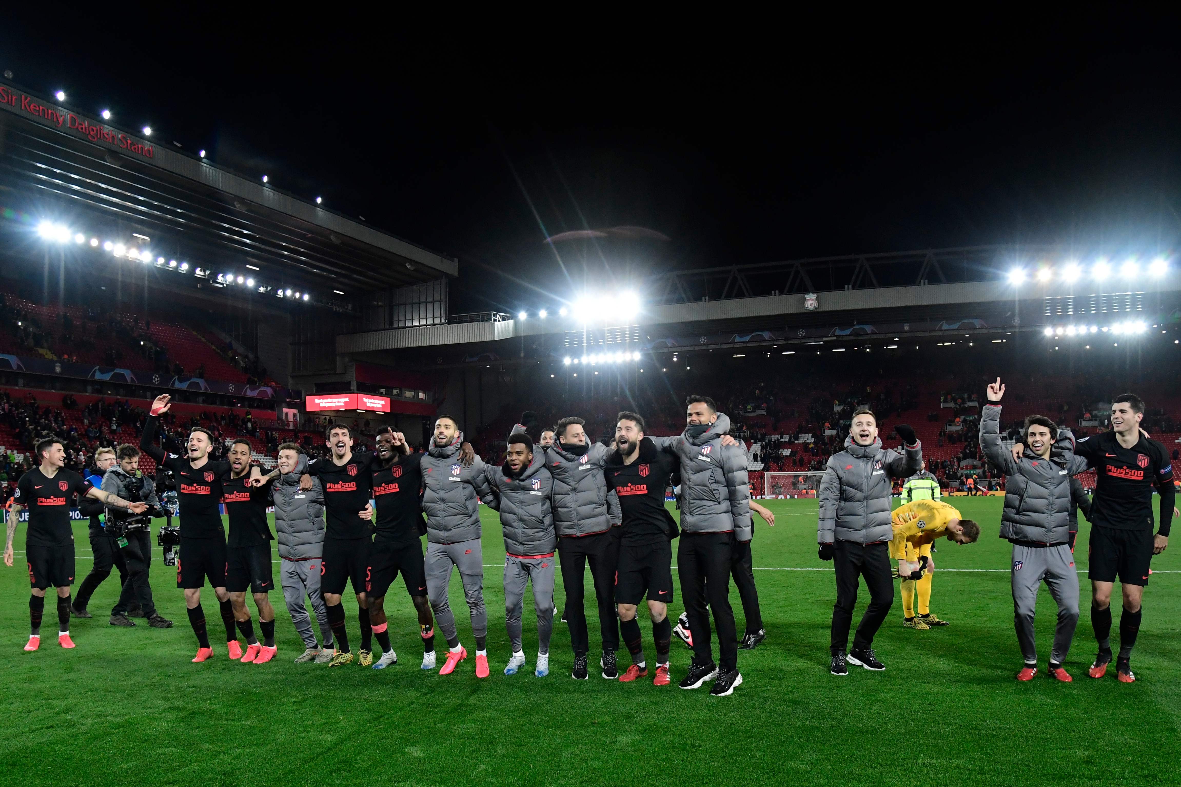 Atletico Madrid's players react at the final whistle during the UEFA Champions league Round of 16 second leg football match between Liverpool and Atletico Madrid at Anfield in Liverpool, north west England on March 11, 2020. (Photo by JAVIER SORIANO / AFP)