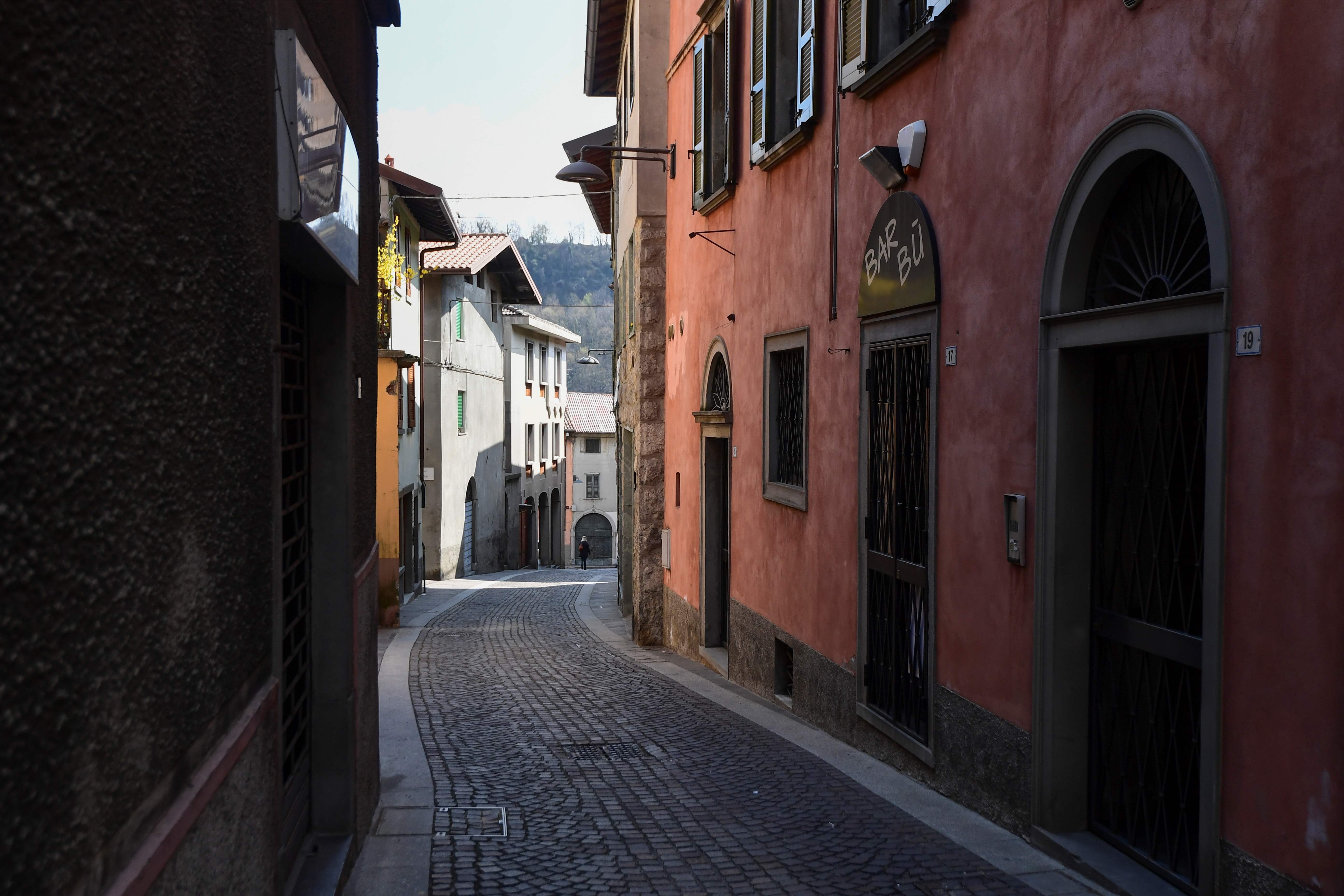 A view shows a deserted street in Vertova near Bergamo, Lombardy, on March 24, 2020, a village of some 5,000 inhabitants where 36 people have died of coronavirus in 23 days. (Photo by MIGUEL MEDINA / AFP)