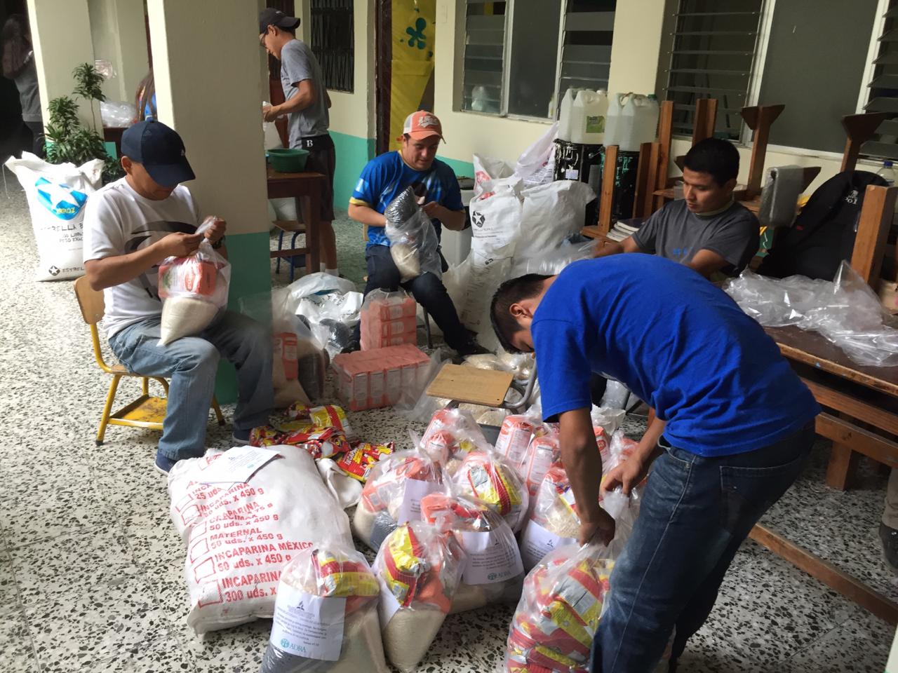 Personas altruistas preparan las bolsas con alimento que serán entregará a familias necesitadas en Quiché. (Foto Prensa Libre: Héctor Cordero) 