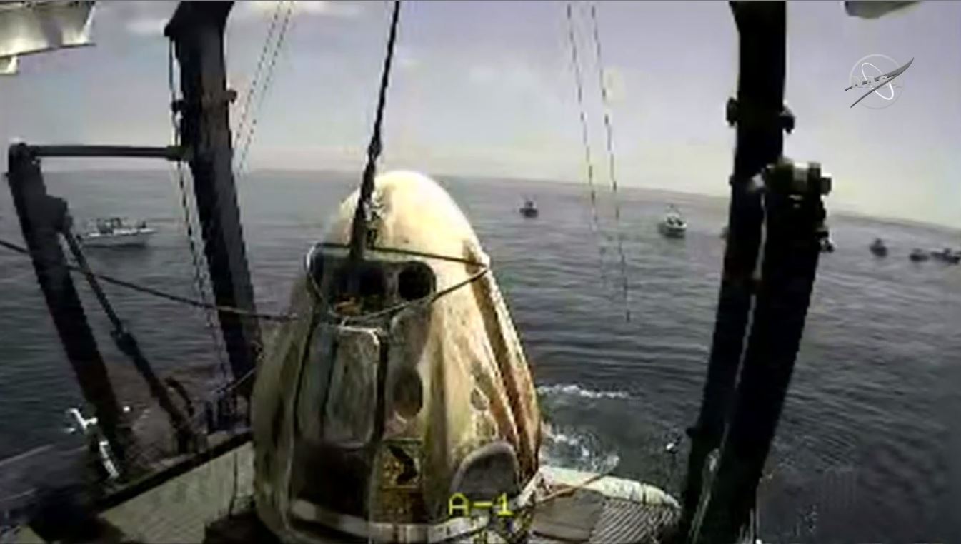This NASA video frame grab image shows Dragon Endeavour shortly after it was hoisted from the Gulf of Mexico off the cost of Pensacola, Florida on the deck of the SpaceX recovery vessel GO Navigator on August 2, 2020. - The Demo-2 test flight for NASA's Commercial Crew Program is the first to deliver astronauts to the International Space Station and return them to Earth onboard a commercially built and operated spacecraft. Behnken and Hurley are returning after spending 64 days in space. (Photo by Handout / NASA / AFP) / RESTRICTED TO EDITORIAL USE - MANDATORY CREDIT "AFP PHOTO /NASA TV /HANDOUT " - NO MARKETING - NO ADVERTISING CAMPAIGNS - DISTRIBUTED AS A SERVICE TO CLIENTS