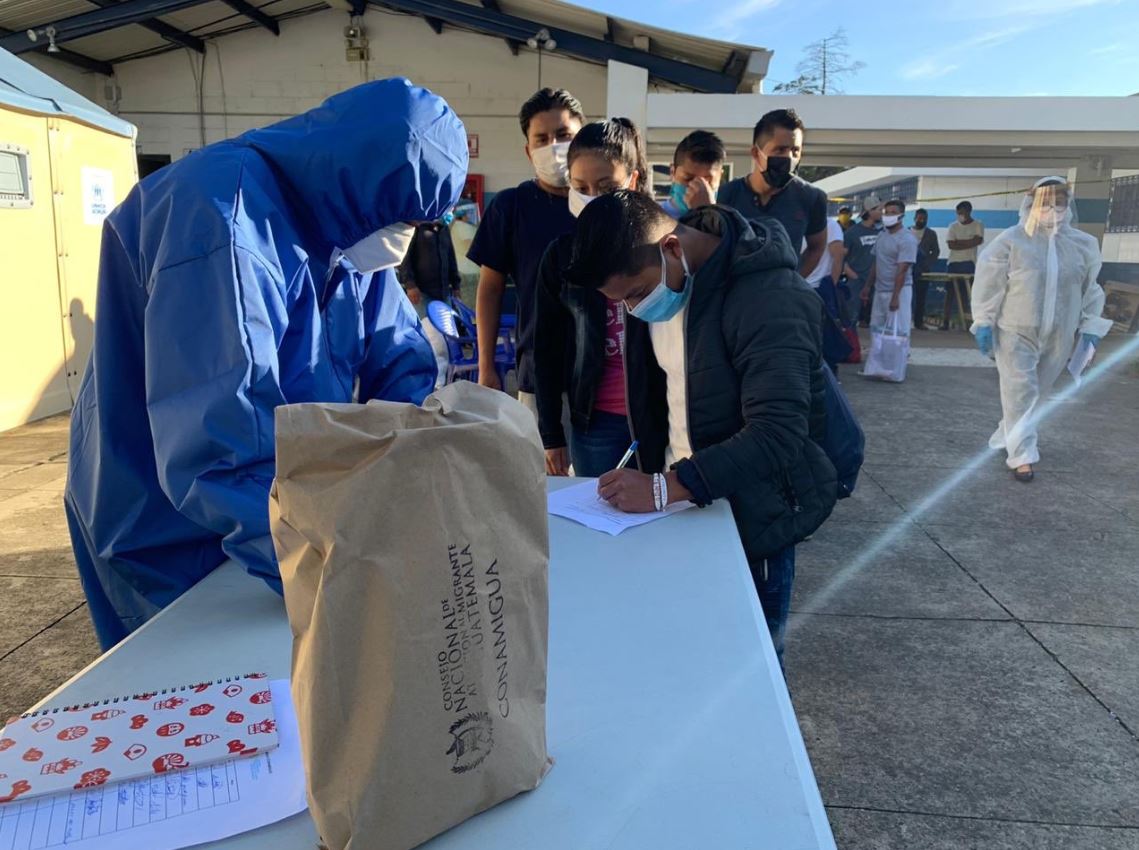 Migrantes reciben refacciones al salir del albergue Ramiro de León al finalizar su cuarentena. (Foto: Conamigua)