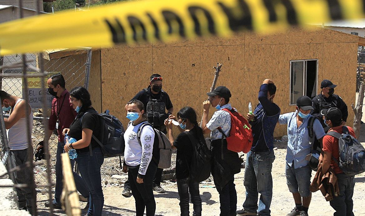 Policías escoltan desde una casa a más de un centenar de indocumentados secuestrados en Ciudad Juárez, Chihuahua. (Foto Prensa Libre: EFE)