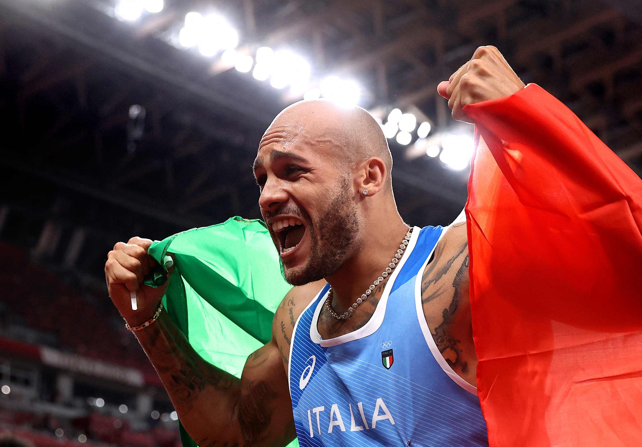 Lamont Marcell Jacobs celebra desués de ganar la final masculina de los 100 metros planos en los Juegos Olímpicos de Tokio 2020. Foto Prensa Libre: AFP.