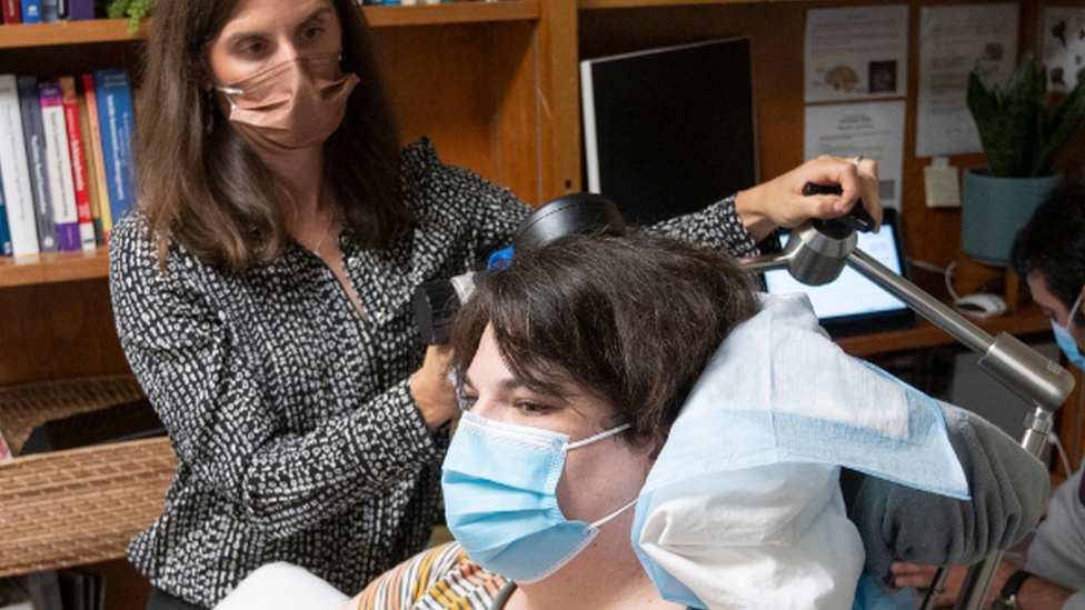 Prof Katherine Scangos checking Sarah's device and progress