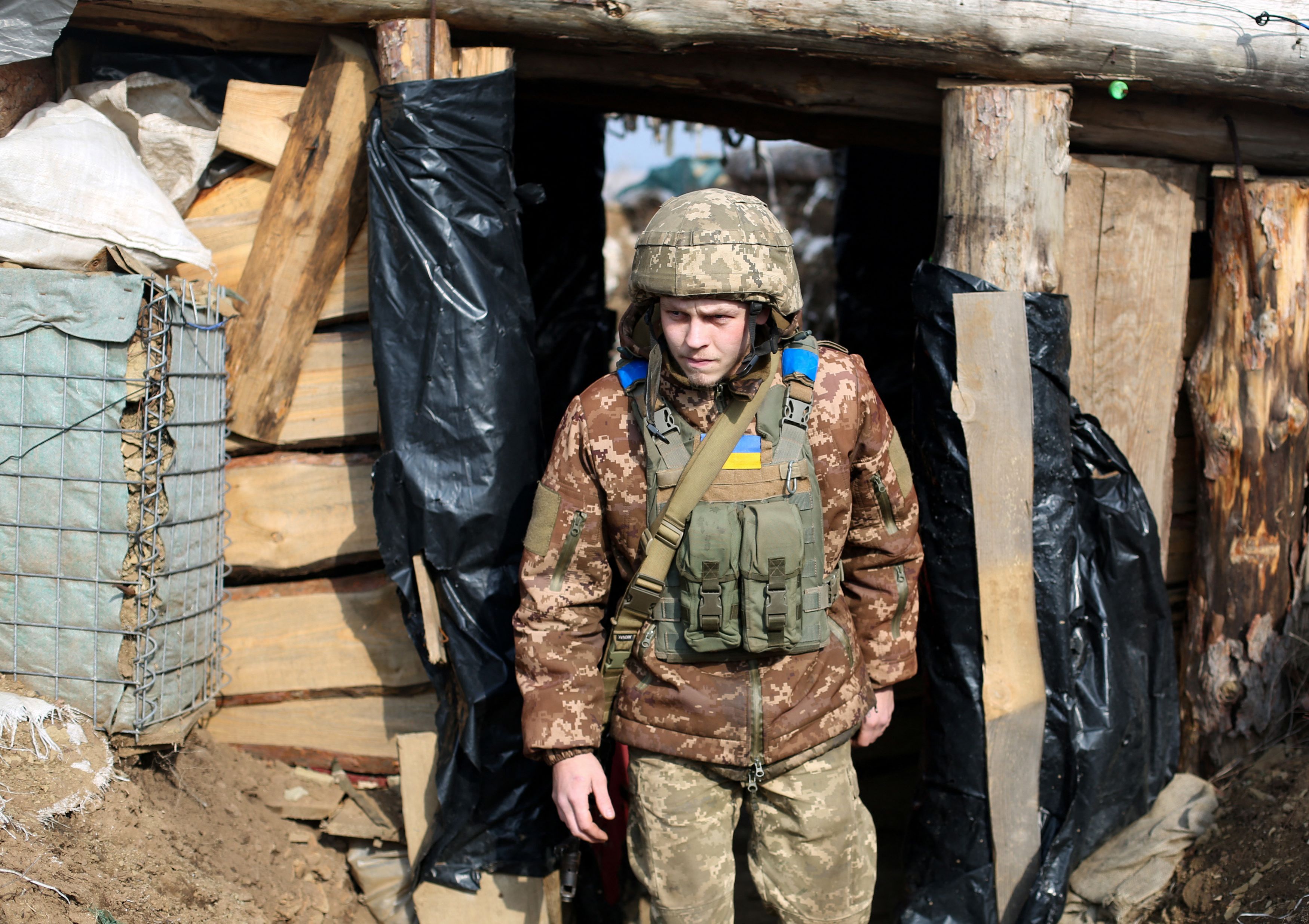 Un soldado ucraniano camina en medio de una trinchera cerca de la frontera de Lugansk. El conflicto repercutiría en todo el planeta y por supuesto en Guatemala. (Foto Prensa Libre: AFP)