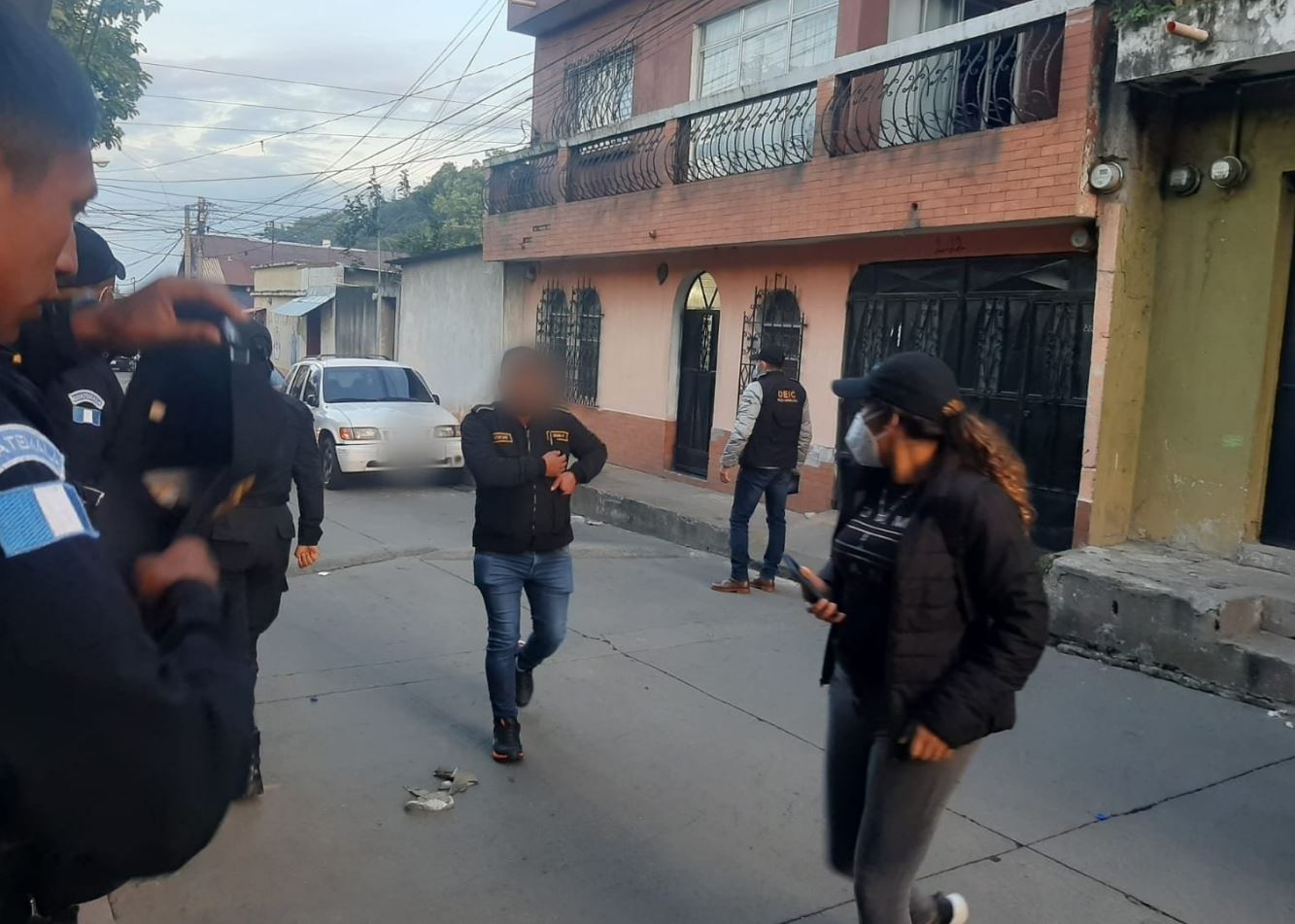 Agentes de la PNC y del MP durante cateos contra estafadores que usaban redes sociales para contactar a sus víctimas y les hacían creer que eran parientes en el extranjero. (Foto Prensa Libre: PNC)