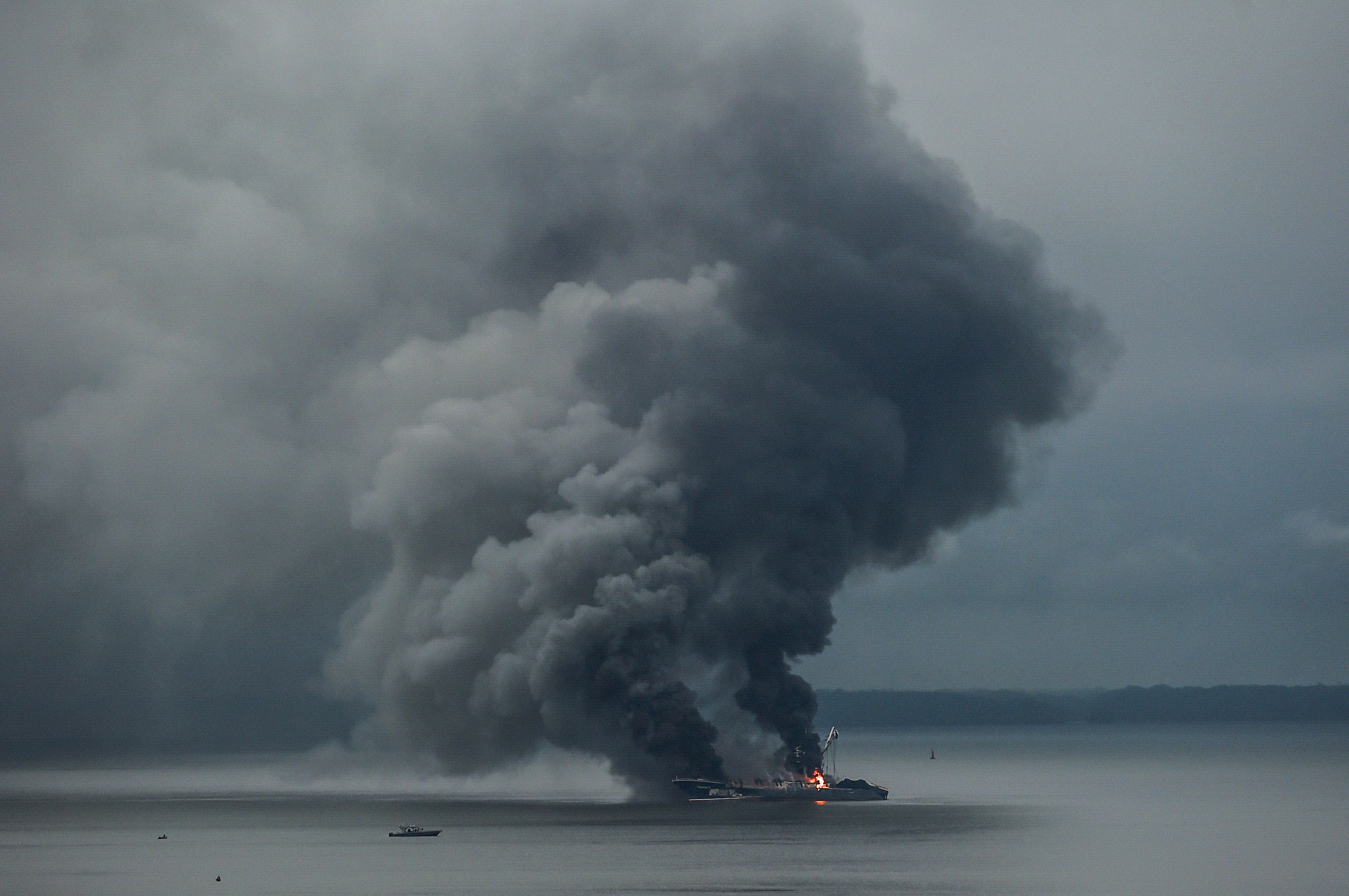 Smoke billows from Venezuelan ship Taurus 1 burning in the Buenaventura Bay, Valle del Cauca department, Colombia, on September 6, 2022. - 29 people were rescued aboard after a fire broke out due to a short-circuit, the Colombian Navy said. The ship was retained on August 29th after being caught practicing illegal fishing in waters under Colombian jurisdiction. (Photo by JOAQUIN SARMIENTO / AFP)