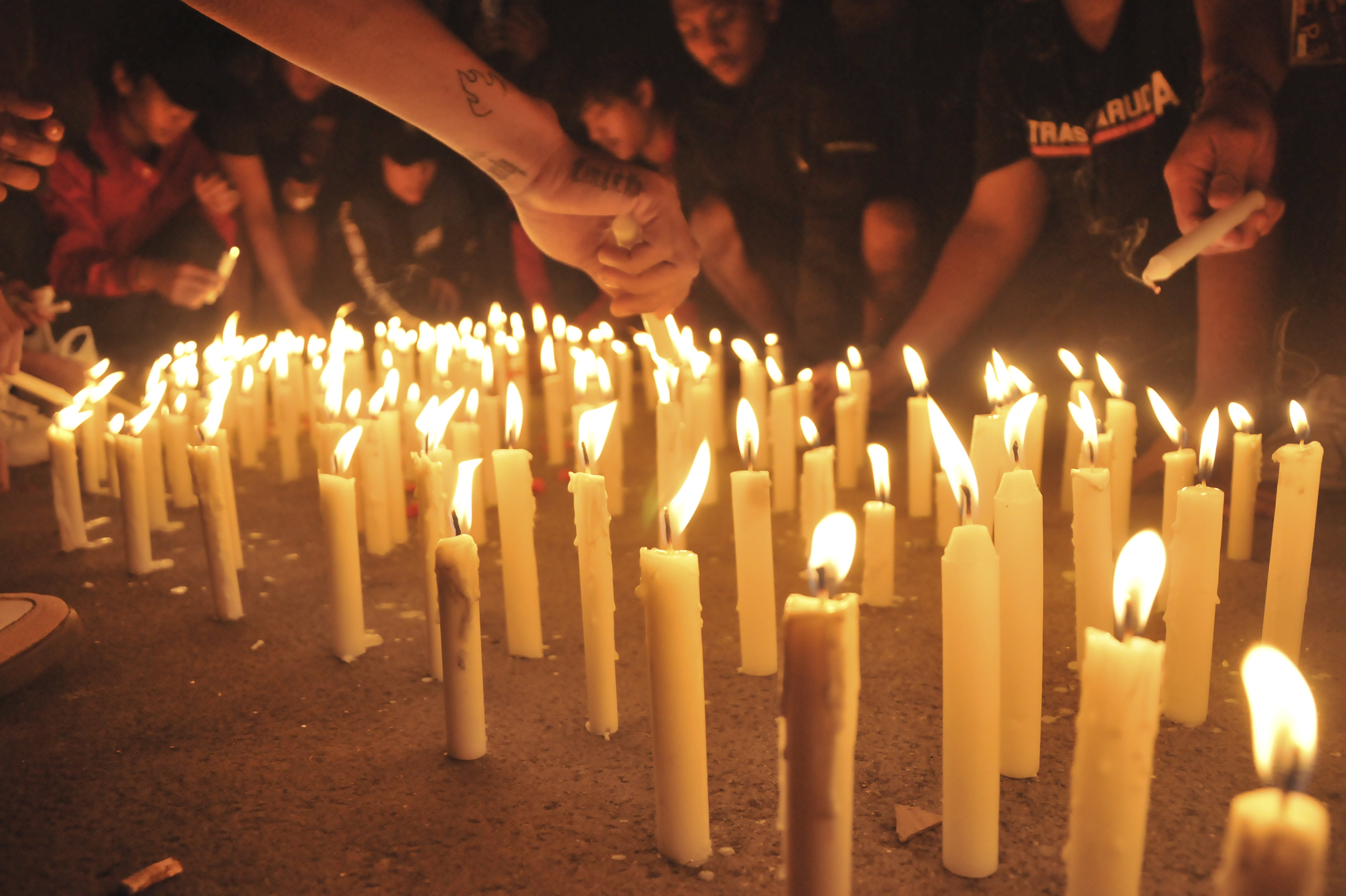 Entusiastas del fútbol encienden velas mientras dan sus condolencias a las víctimas del motín y la estampida del partido de fútbol, en Yakarta, Indonesia, el 2 de octubre de 2022. El jefe de la Policía Nacional de Indonesia, general Listyo Sigid Prabowo, anunció que al menos 125 personas, incluidos policías, murieron después Los fanáticos del fútbol indonesio entraron al campo causando pánico y una estampida después del partido entre Arema FC y Persebaya Surabaya en Java Oriental el 01 de octubre. La Asociación de Fútbol de Indonesia suspendió temporalmente la competición de la Liga 1 2022/2023 durante una semana y prohibió que el Arema FC fuera el anfitrión del resto de la competición de esta temporada. Foto Prensa Libre (EFE)