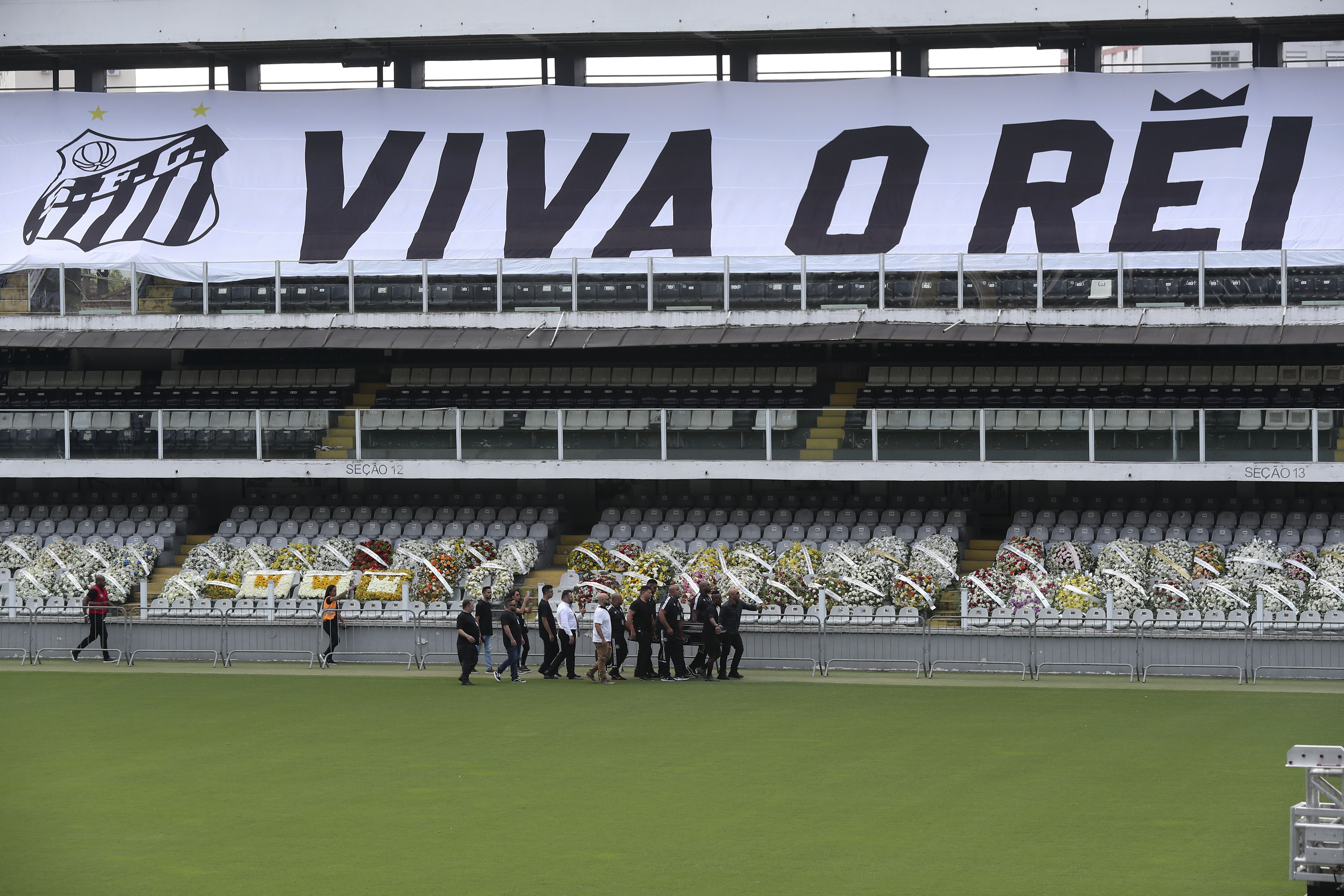 El hijo de Pelé Edinho (d), el exfutbolista Zé Roberto (2d) y amigos del Edson Arantes do Nascimento 'Pelé participan en el velatorio de Edson Arantes do Nascimento 'Pelé' en el estadio Vila Belmiro en la ciudad de Santos, Brasil. (Foto Prensa Libre: EFE)