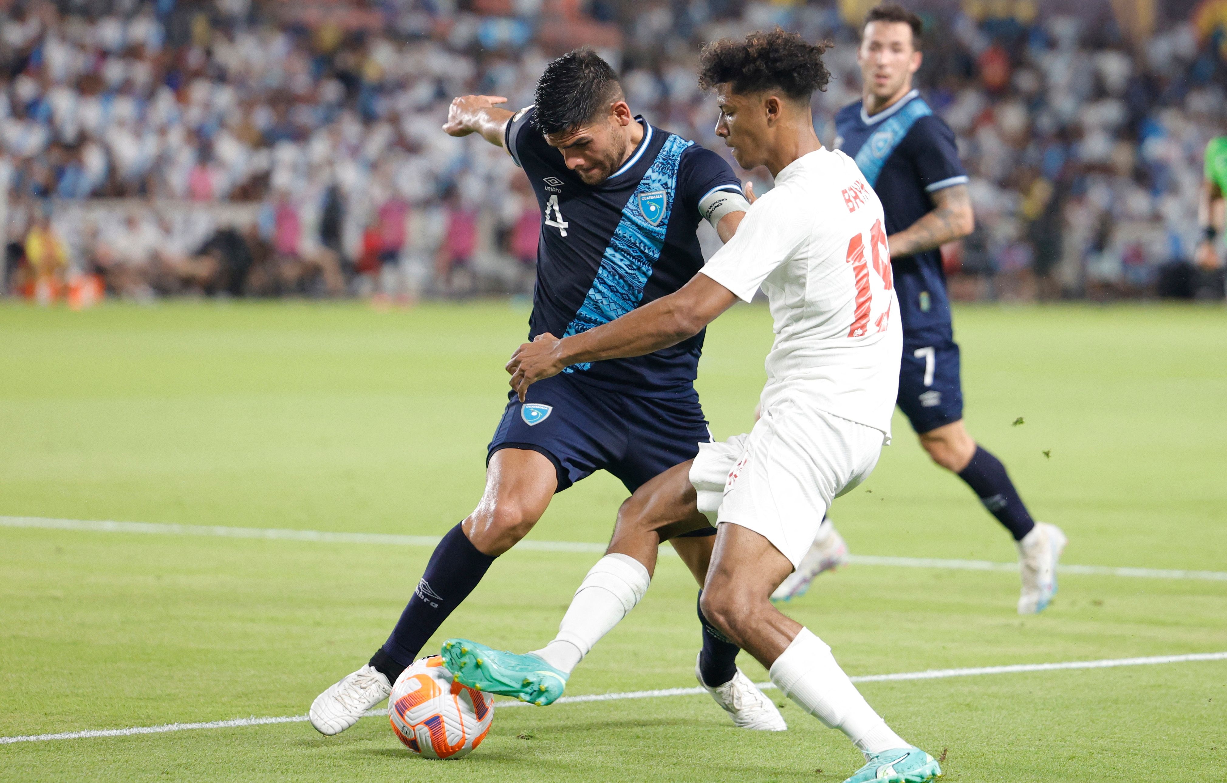 HOUSTON, TEXAS - JULY 01: José Carlos Pinto #4 of Guatemala defends against Charles-Andreas Brym #19 of Canada during the second half of the Concacaf Gold Cup match at Shell Energy Stadium on July 01, 2023 in Houston, Texas.   Carmen Mandato/Getty Images/AFP (Photo by Carmen Mandato / GETTY IMAGES NORTH AMERICA / Getty Images via AFP)