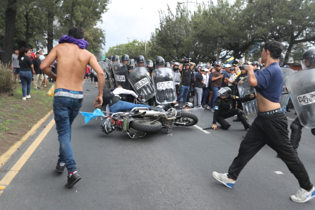 Motoristas se colocan frente a los agentes antimotines que se presentaron en el Periférico para liberar el paso tras segundo día de bloqueo en este lugar.