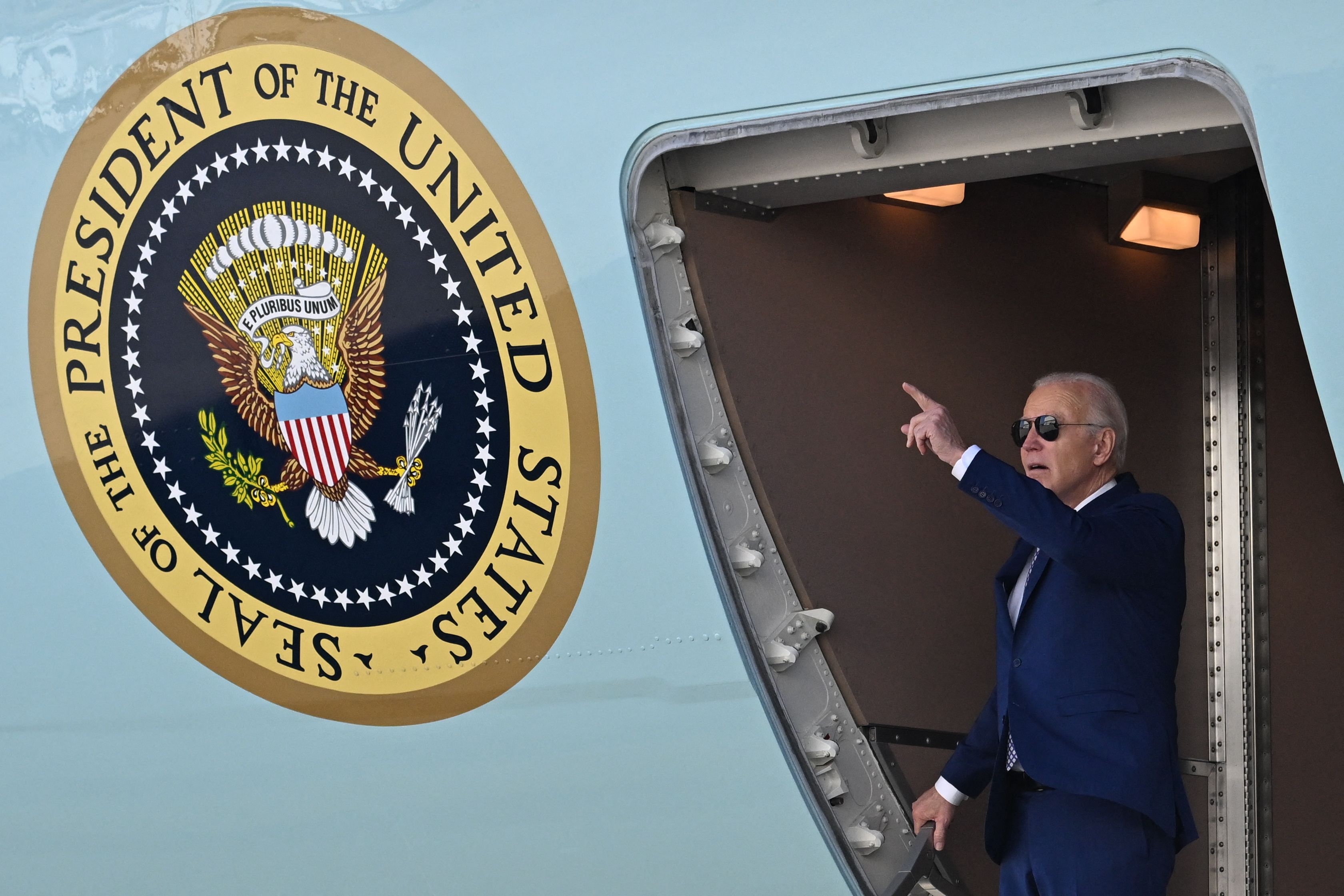 US President Joe Biden gestures as he arrives at John F. Kennedy International Airport, in Queens, New York on February 26, 2024. Biden is in New York to attend a campaign event. (Photo by Jim WATSON / AFP)