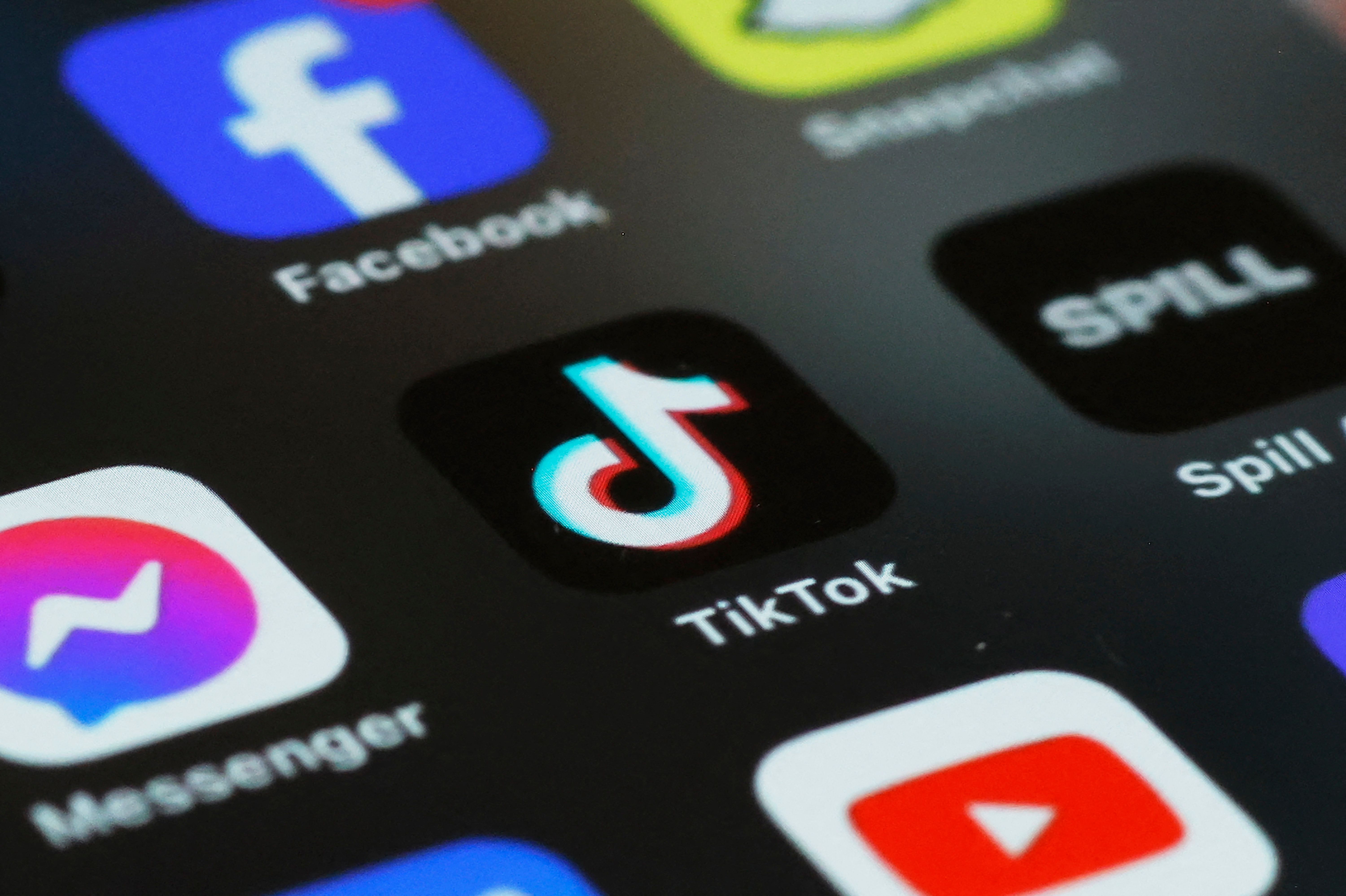 (FILES)  In this photo illustration, the TikTok app is seen on a phone on March 13, 2024 in New York City. TikTok sharply denounced the passage on April 20, 2024,  by the US House of Representatives of a bill that threatens to ban the popular social-media platform unless it severs its ties to Beijing. (Photo by Michael M. Santiago / GETTY IMAGES NORTH AMERICA / AFP)