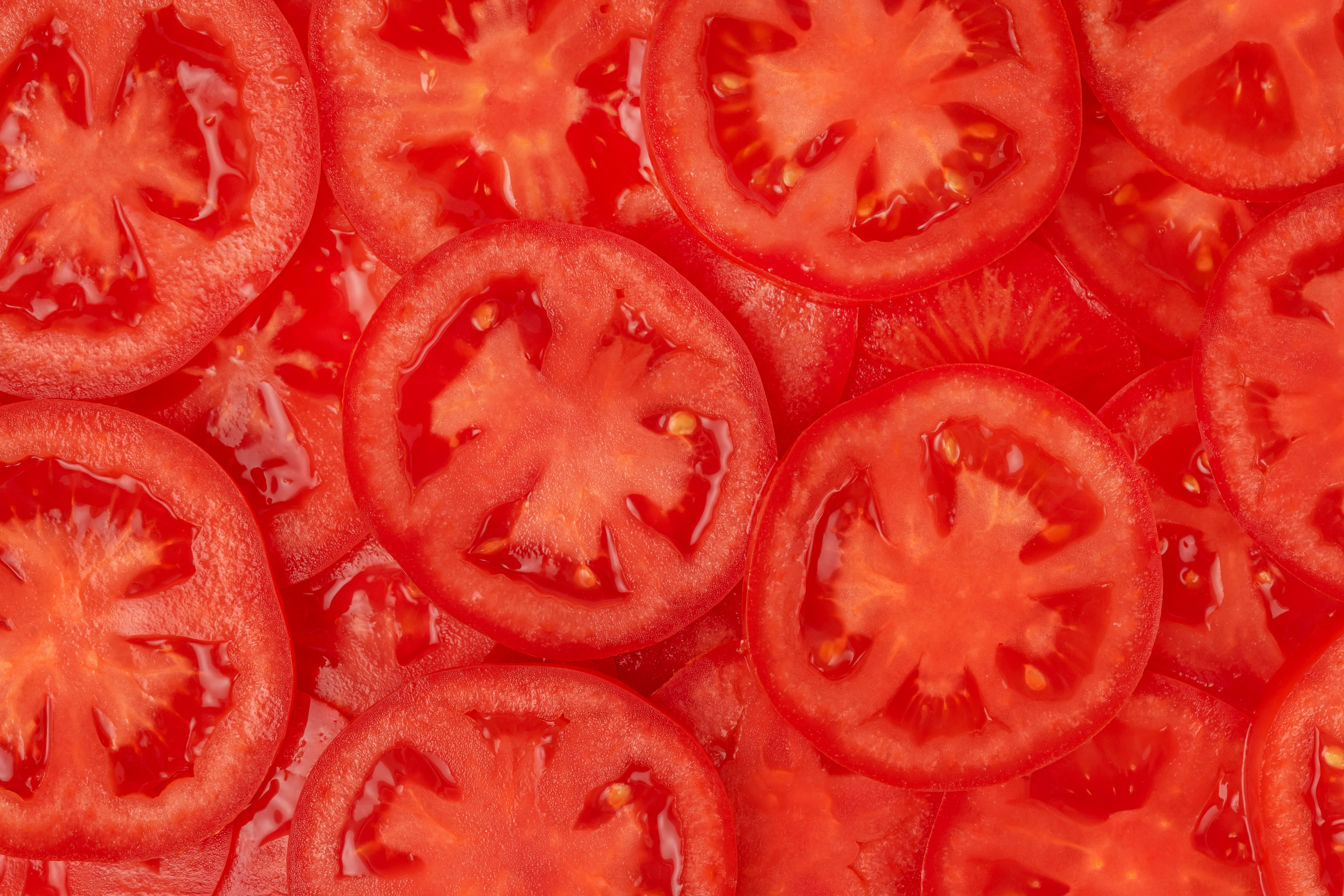 Pattern of sliced red tomato, close up.