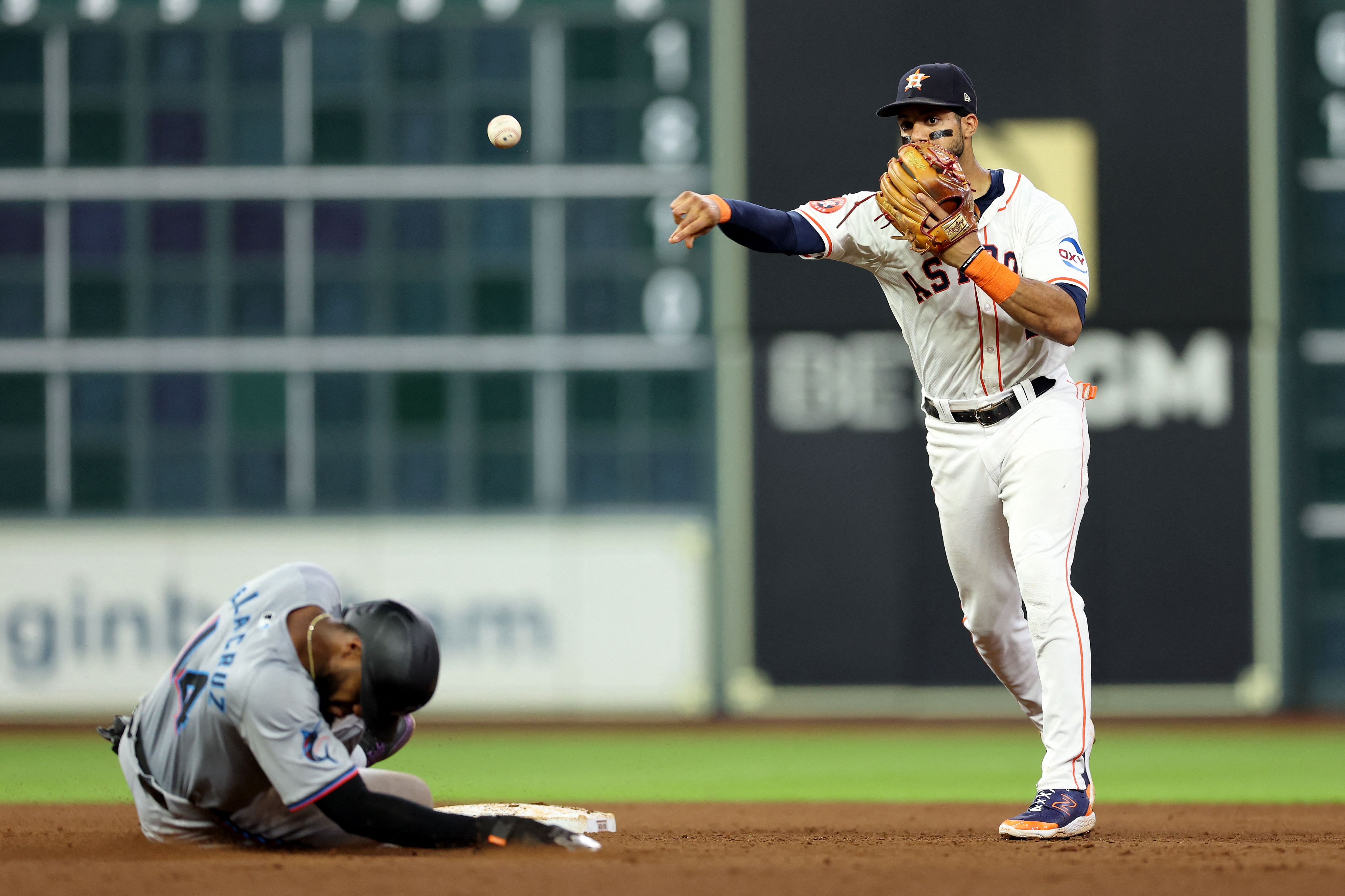 HOUSTON, TEXAS - JULY 11: Jeremy Pena #3 of the Houston Astros forces Bryan De La Cruz #14 of the Miami Marlins out at second and throws to first for a double play in the fifth innng at Minute Maid Park on July 11, 2024 in Houston, Texas.   Tim Warner/Getty Images/AFP (Photo by Tim Warner / GETTY IMAGES NORTH AMERICA / Getty Images via AFP)