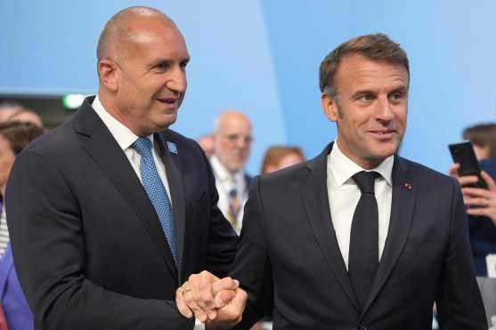 Bulgaria's President Rumen Radev (L) shakes hands with France's President Emmanuel Macron ahead of the Opening Plenary session of the European Political Community meeting, at Blenheim Palace in Woodstock, southern England, on July 18, 2024. (Photo by Kin Cheung / POOL / AFP)